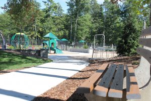 park bench sidewalk and playground