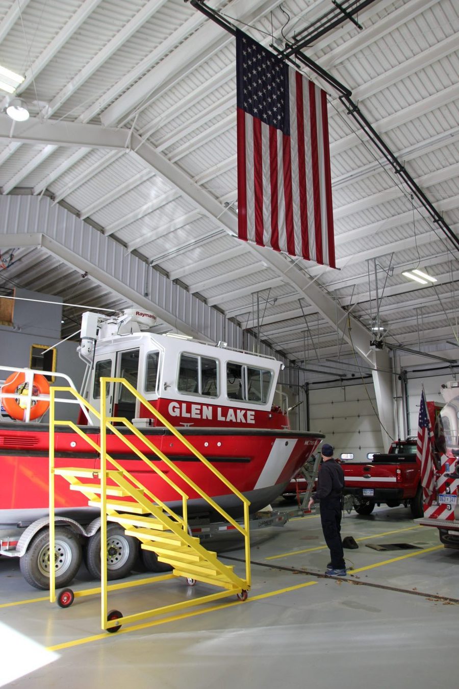 IMG_8835 inside of station, vehicles parked, american flag haning from ceiling